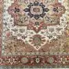 This hand knotted Indo Serapi rug lends a traditional feel to your favorite room. It carries bold geo-floral design elements along with a pleasing balance of soft colors.